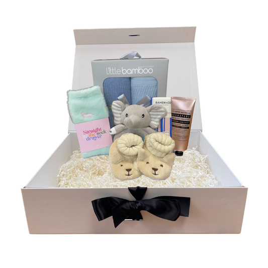 Baby boy gift set with items including socks, booties, and a toy in a box with 'Little Bamboo' branding.