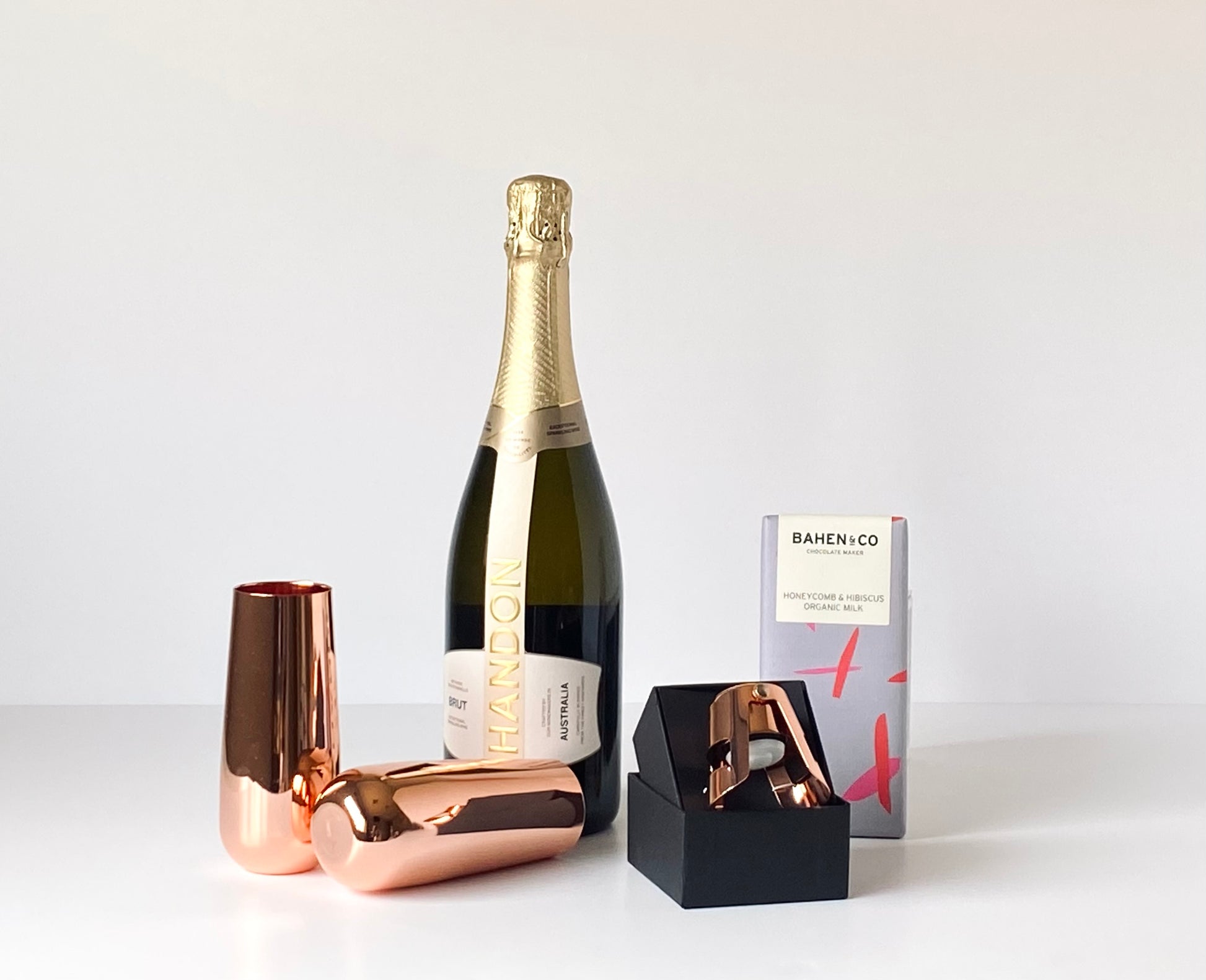 The Golden Toast contents - Chandon NV Brut, Clinq copper champagne flutes and stopper and Bahen & Co chocolate block - Gift Bento
