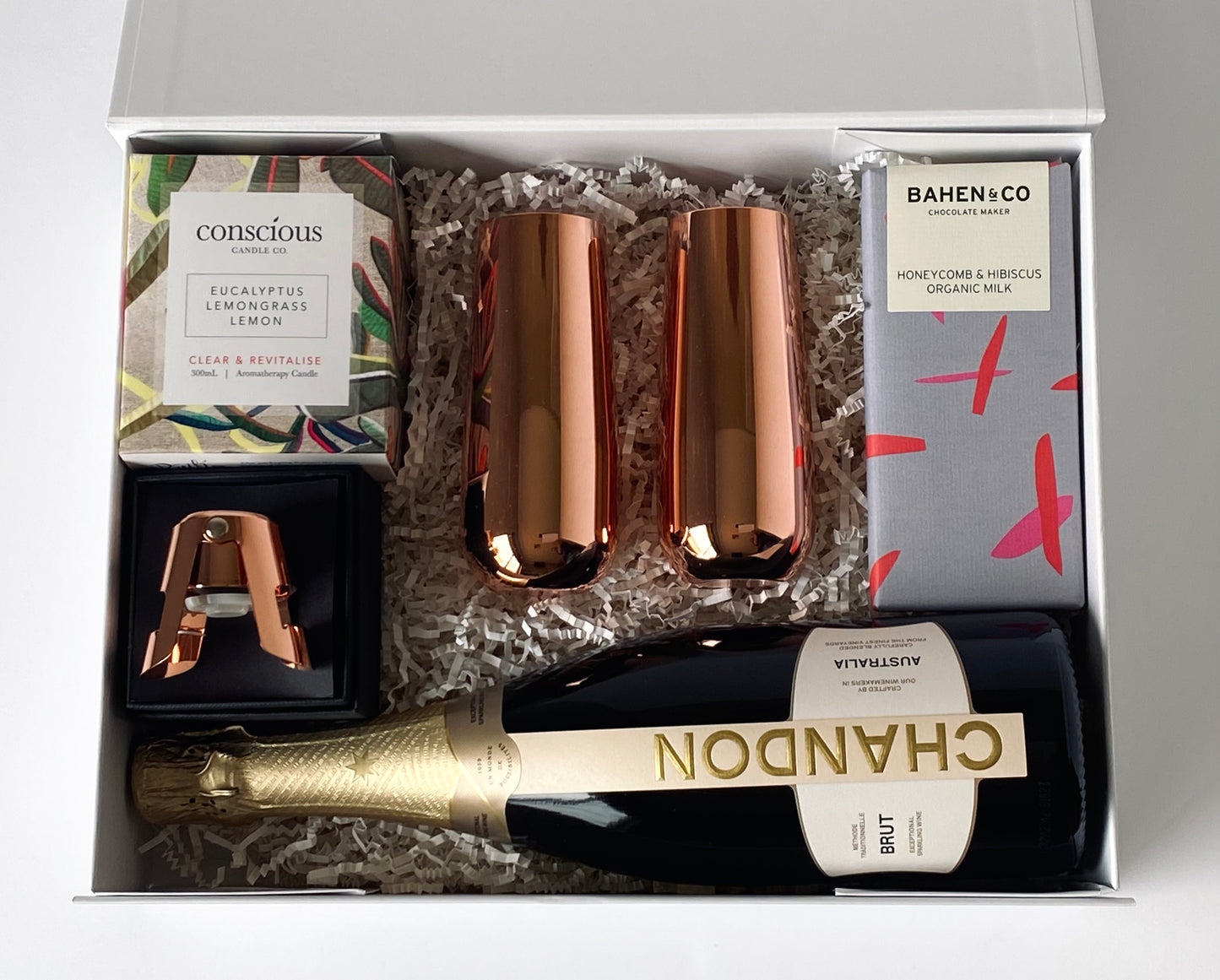 The Luxe Celebration - Chandon sparkling, copper flutes, stopper, candle and chocolate inside gift box, top-down view - Gift Bento